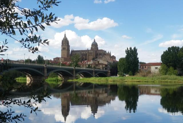 a stone bridge across the Tormes River to a building