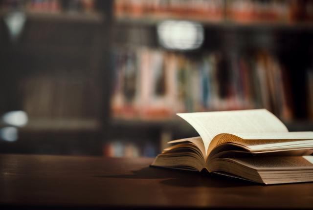 open book on a desk in a library