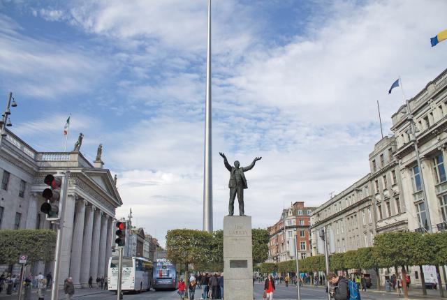 A view of buildings in Dublin City Center with the needle-like Spire Monument in the background