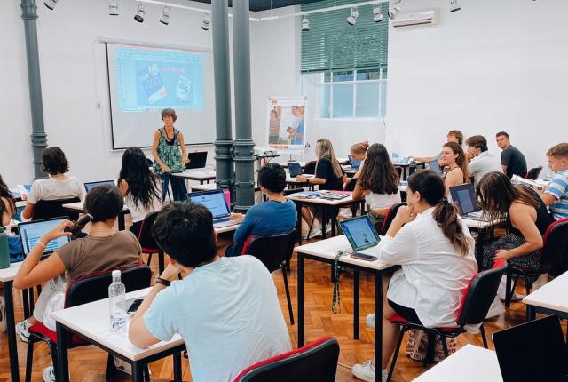 Students in Milan, Italy take notes from a lecture.