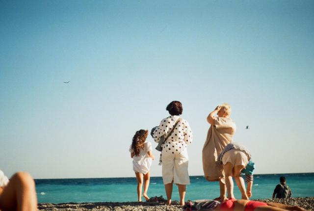 A family stands on the beach in Nice, France.