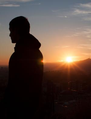 a student looks out over Barcelona from the Bunkers during sunset