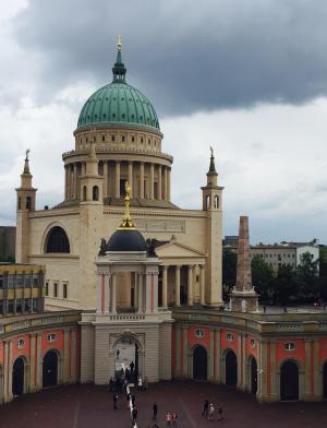 large layered gothic-style building with a pale green dome