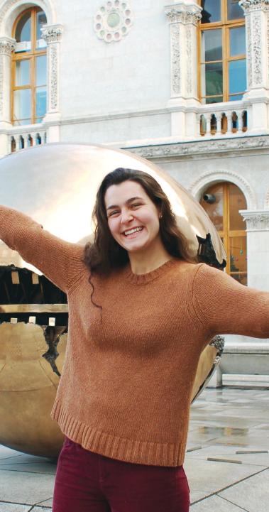 a student poses for a photo in front of Trinity College Dublin