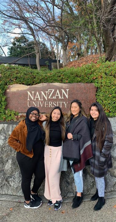 students pose for a photo in front of the Nanzan University sign in Nagoya