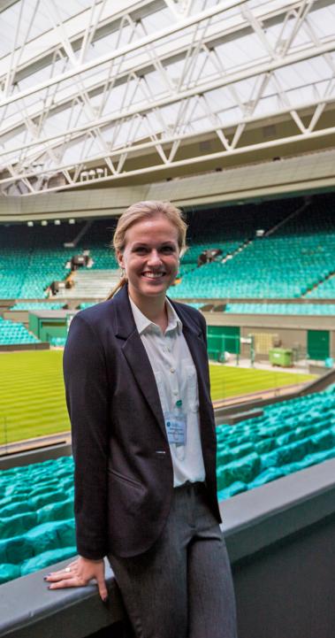 a student intern standing in an empty sports arena