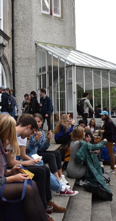 students sitting outside the architecture building at University College Dublin