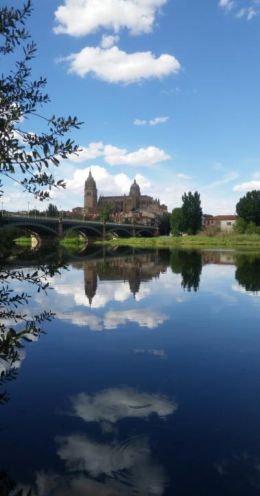 a stone bridge across the Tormes River to a building