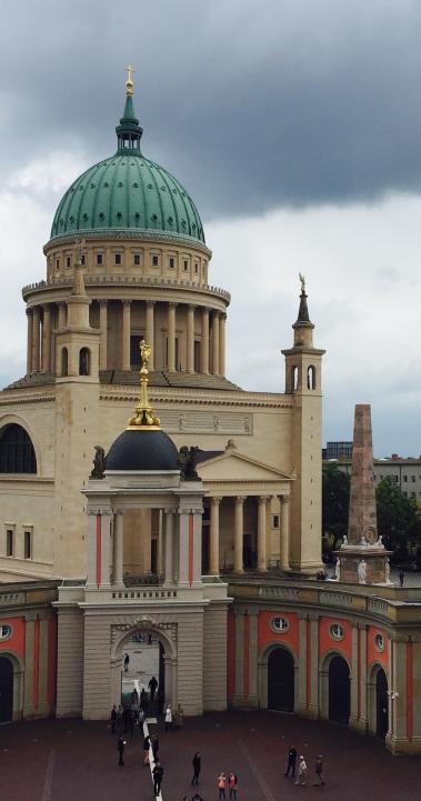 large layered gothic-style building with a pale green dome