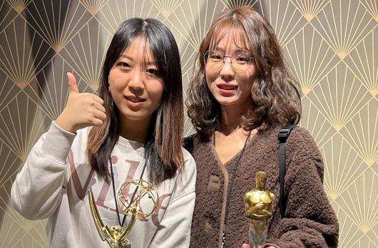 Two students during UCLA Data Science study tour, at a museum with Grammys