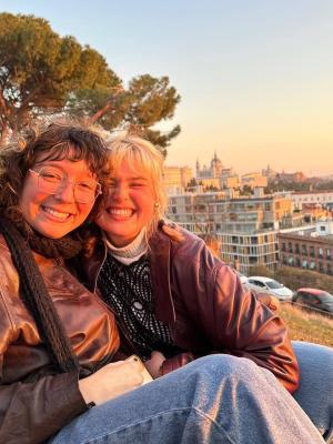 Two students sit high above the city.