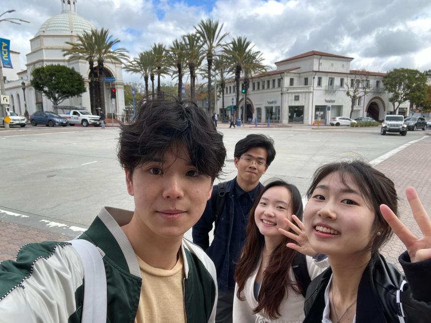 UCLA Big Data & Business Application students pose for a photo at UCLA in front of palm trees