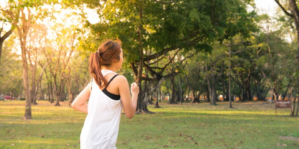 Woman running in a  park on a sunny day