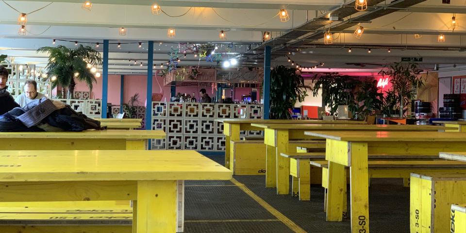 Peckham Levels, large yellow tables in an industrial-style cafe