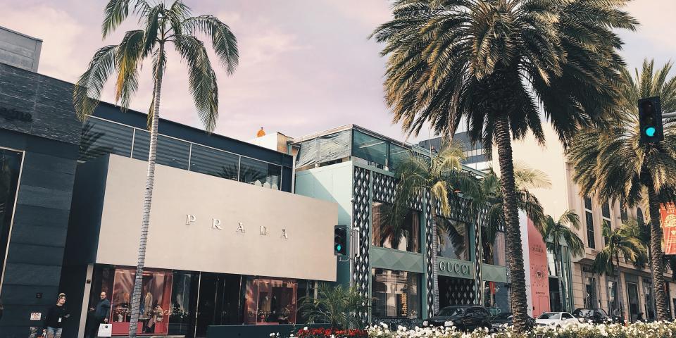storefront and palm trees along rodeo drive