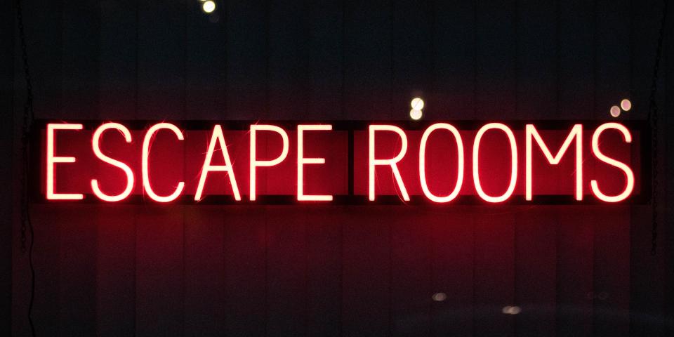 a neon sign that says escape rooms